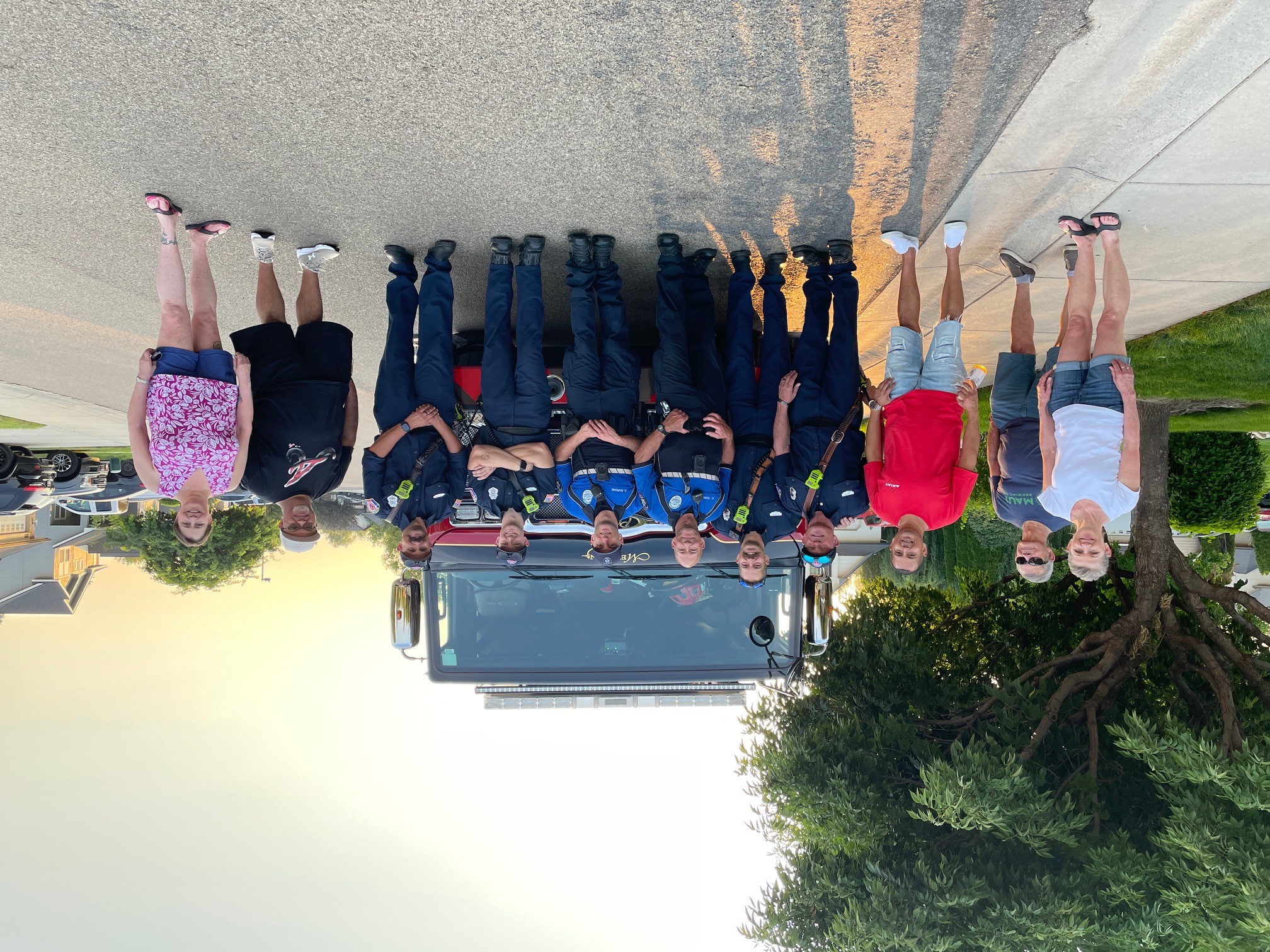 National Night Out goup photo of staff from Meridian police, fire departments with neighbors in front of a fire truck